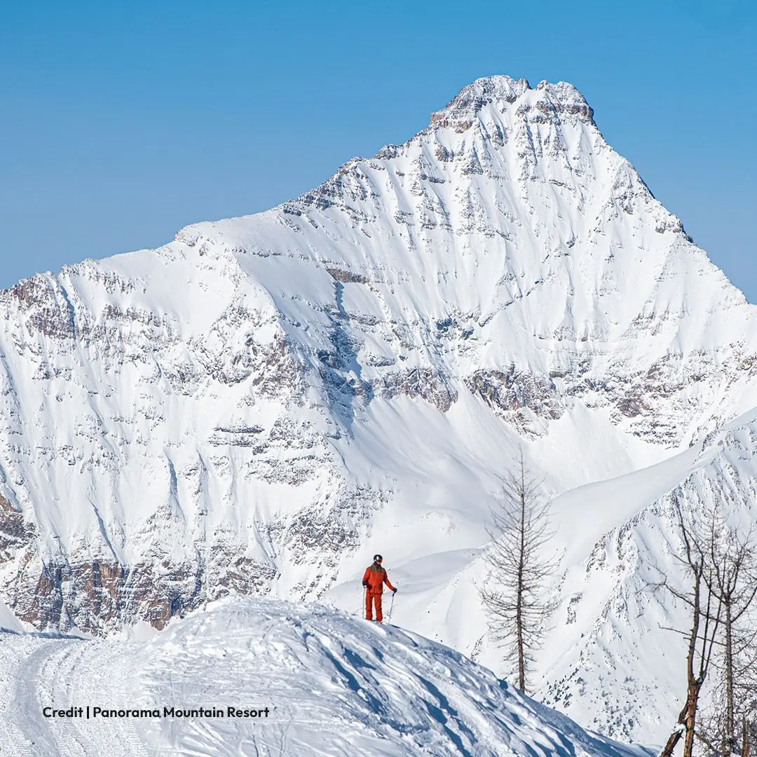 Man in red snow suit on snowy mountain