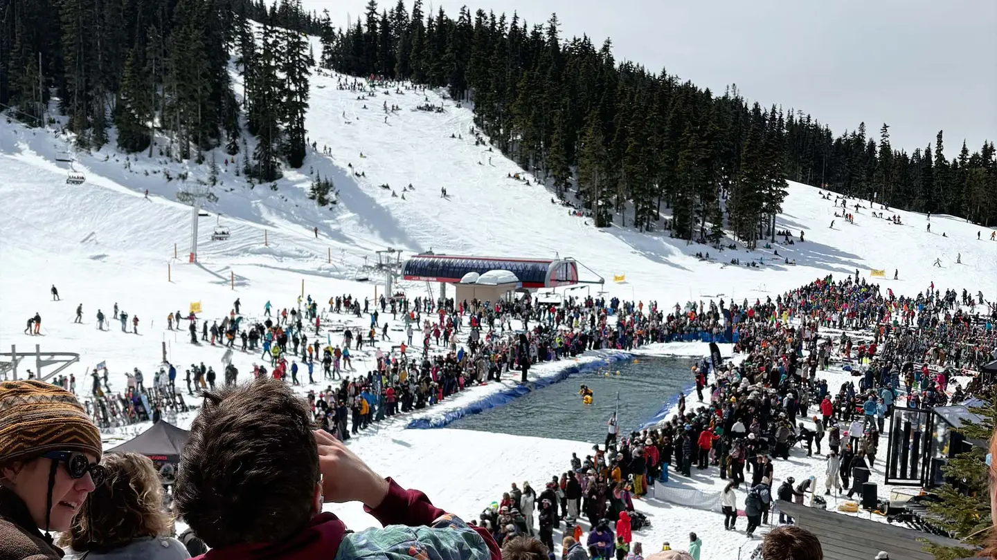 Ski slopes and a group of people around a lake