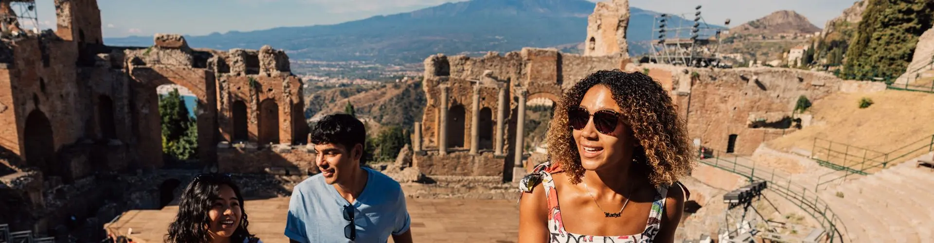 Girl with sunglasses standing in amphitheatre