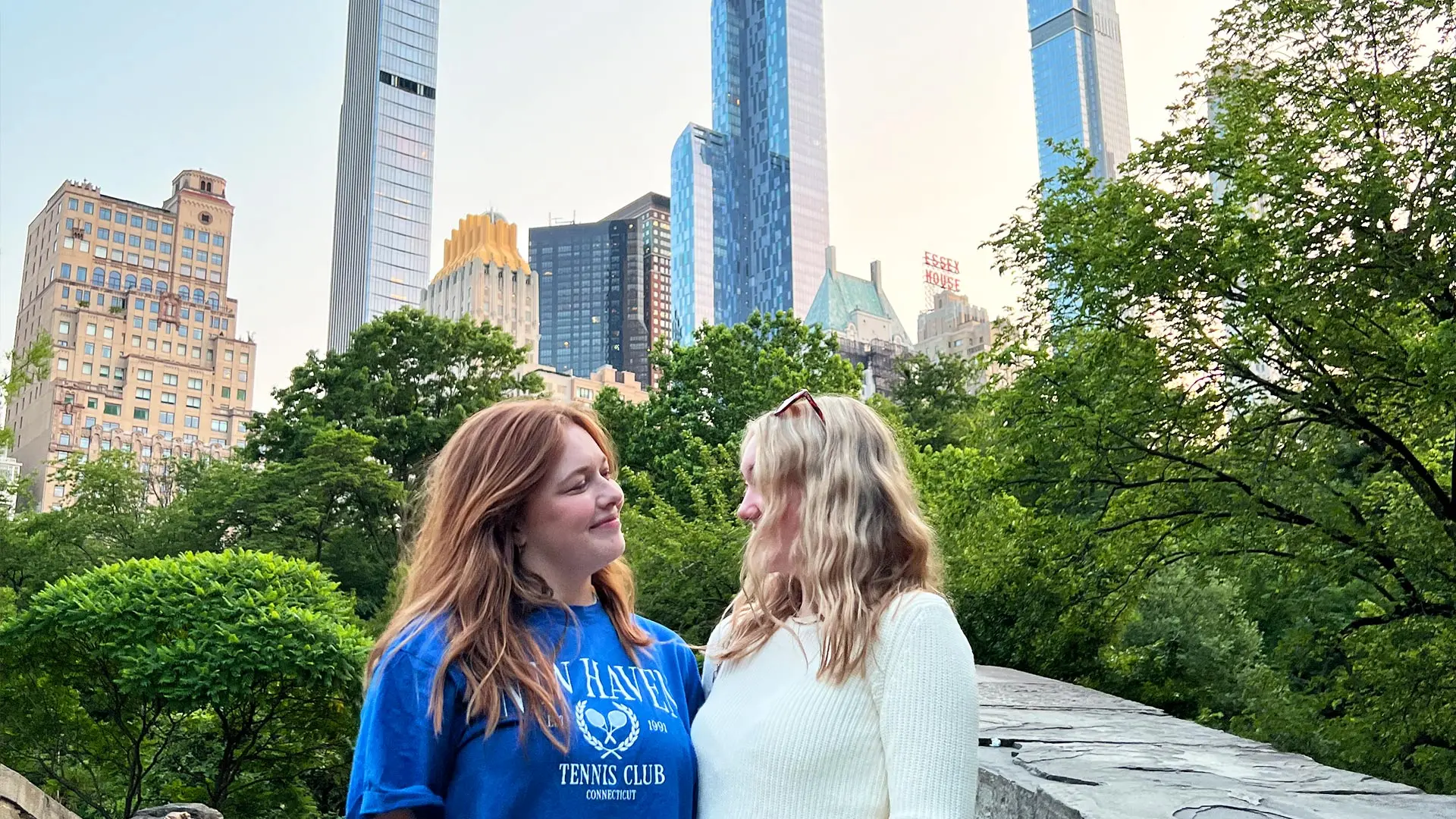 Two girls look at each other in Central Park, NYC.