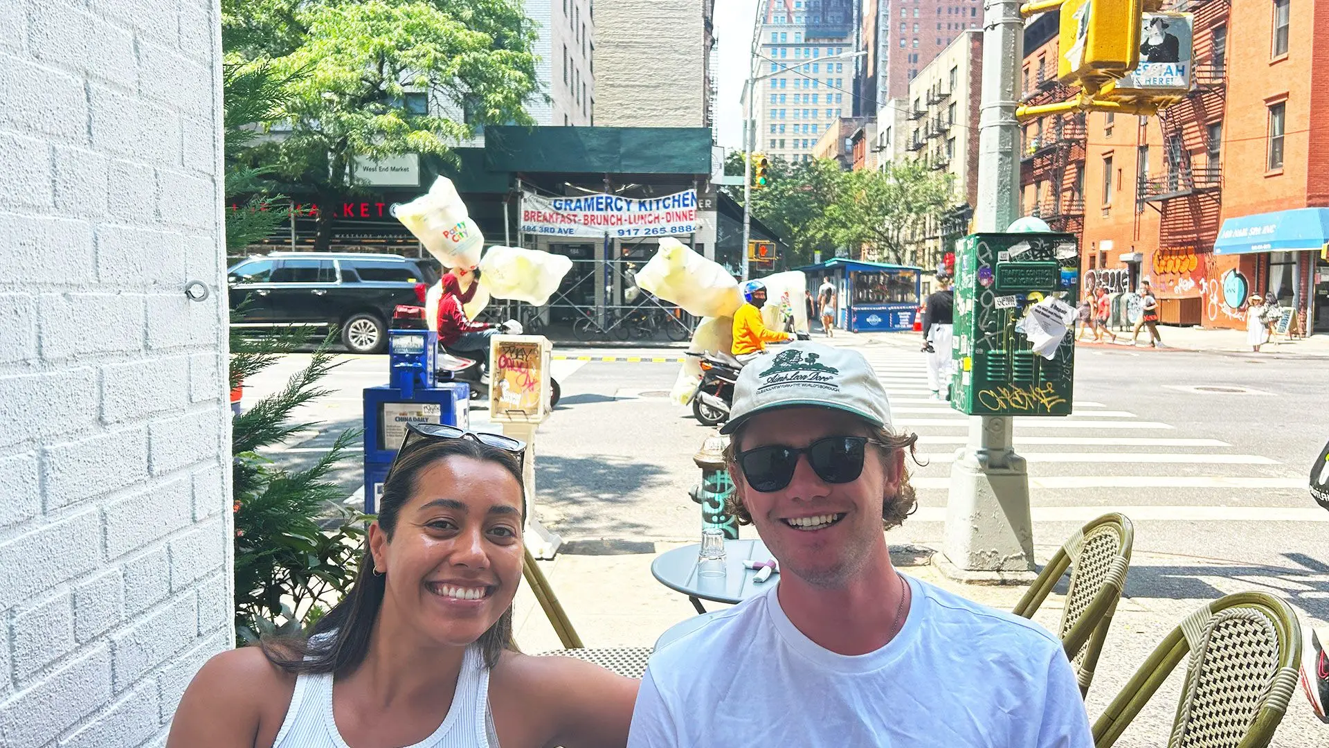 Girl and guy sit at cross roads in NYC