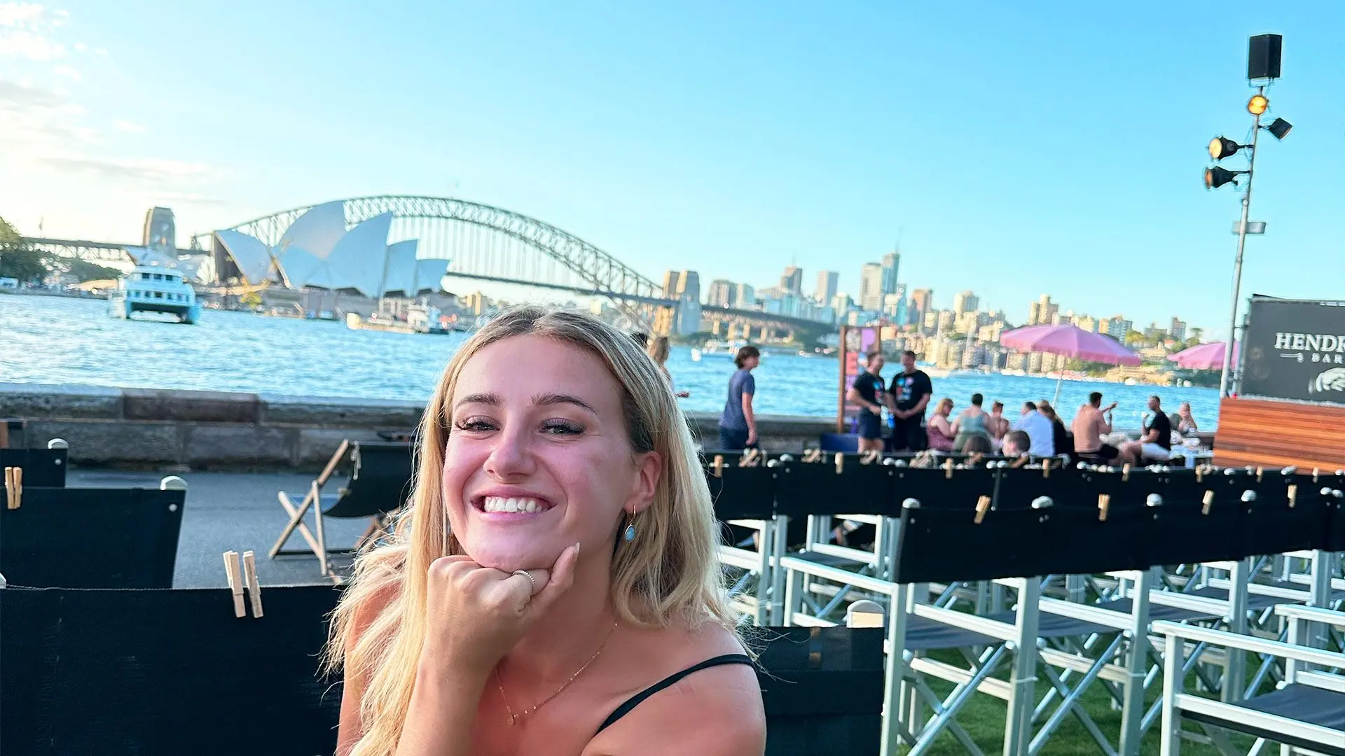 Girl smile for photo with Sydney harbour in the background