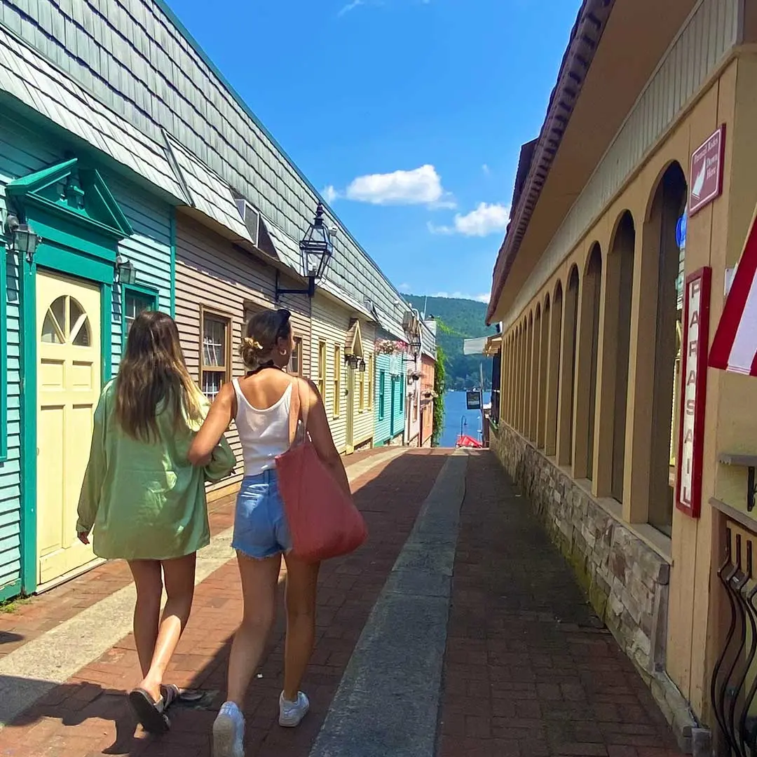 2 girls walk down boardwalk