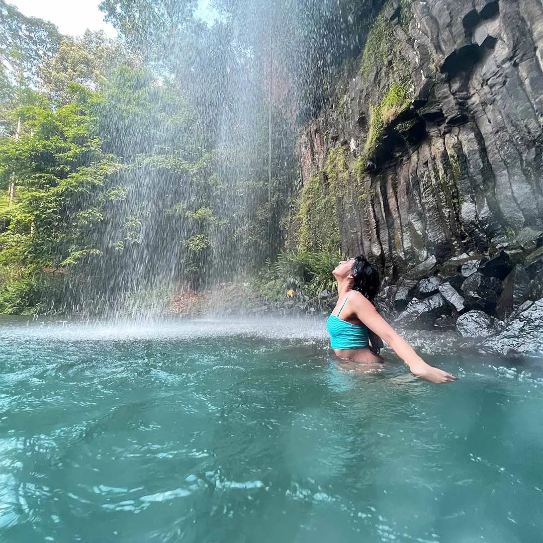 Girl under waterfall