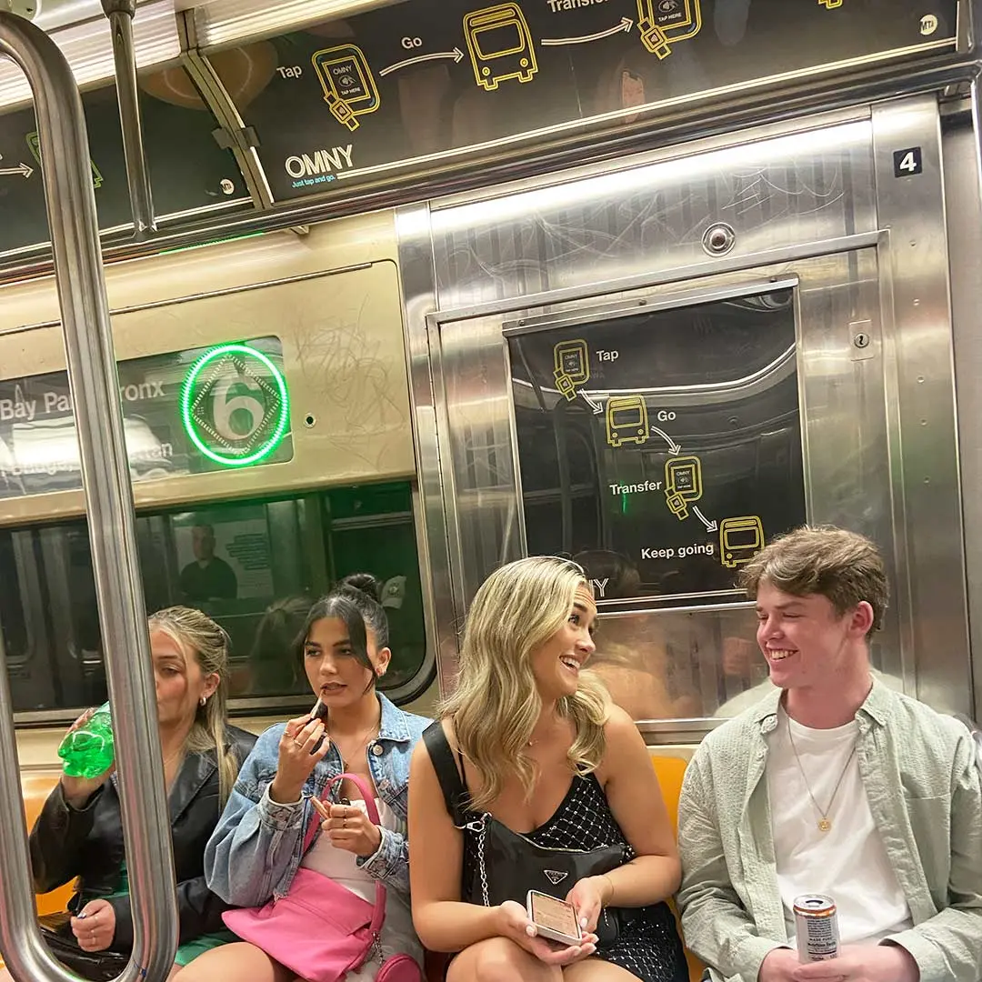 Group of friends sitting on subway.