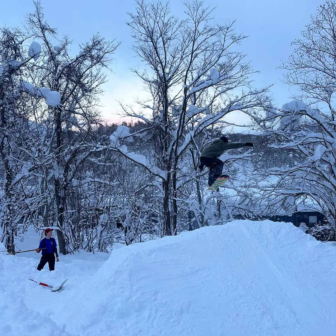 Guy jumps off ramp in snow