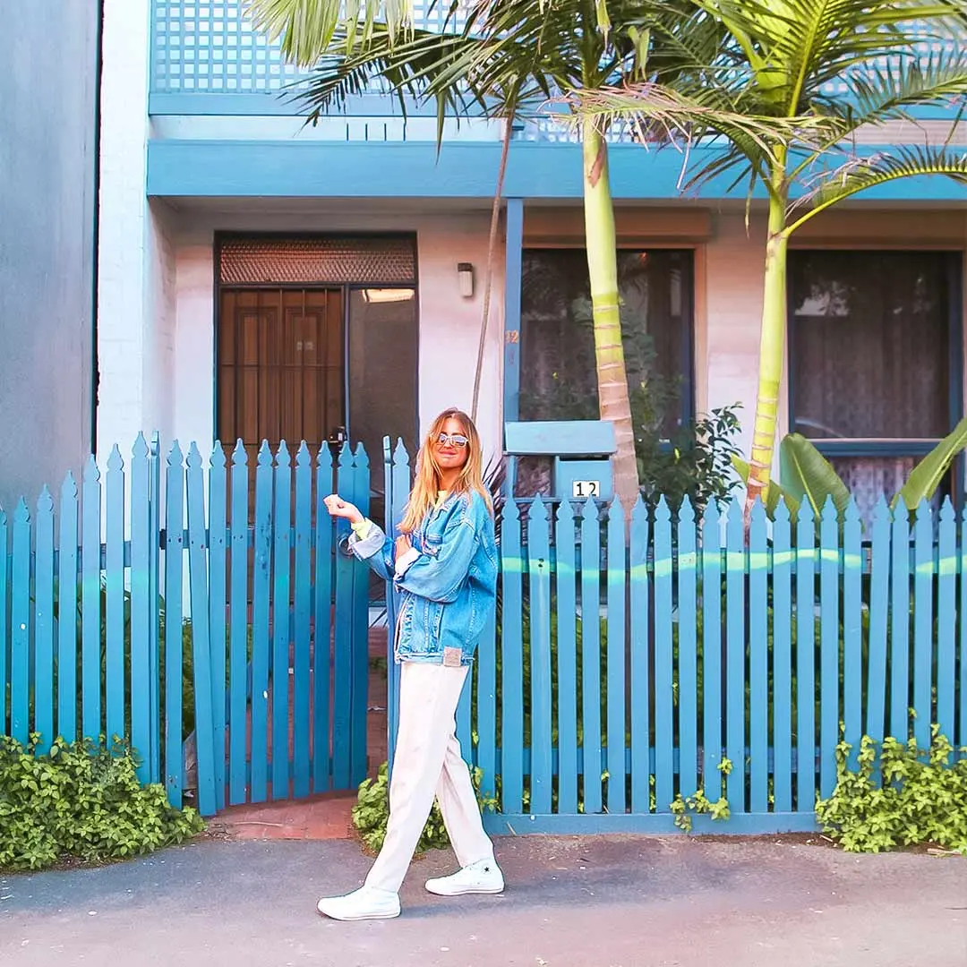 Girl smiles in front of beach house