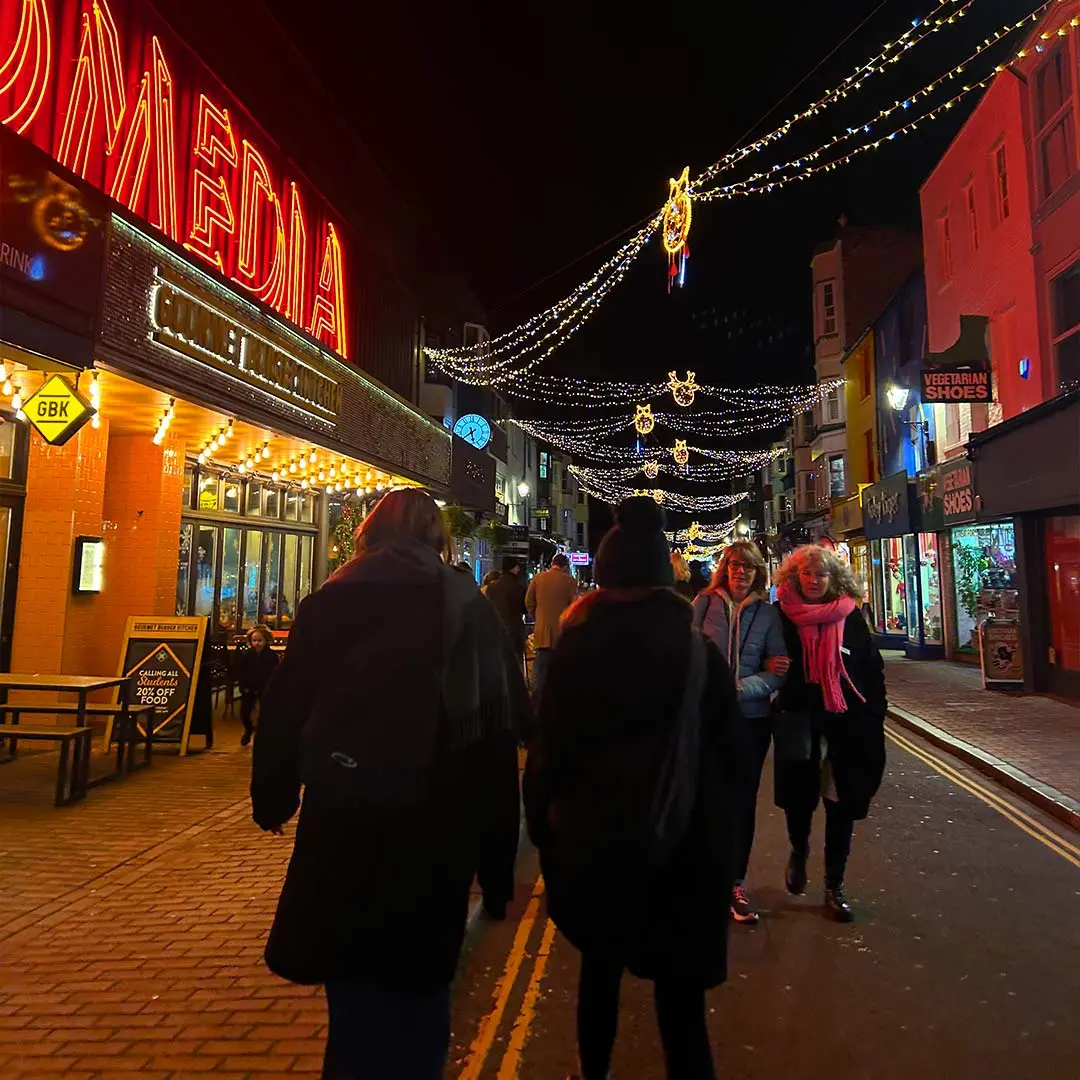 Girls walk through market at night