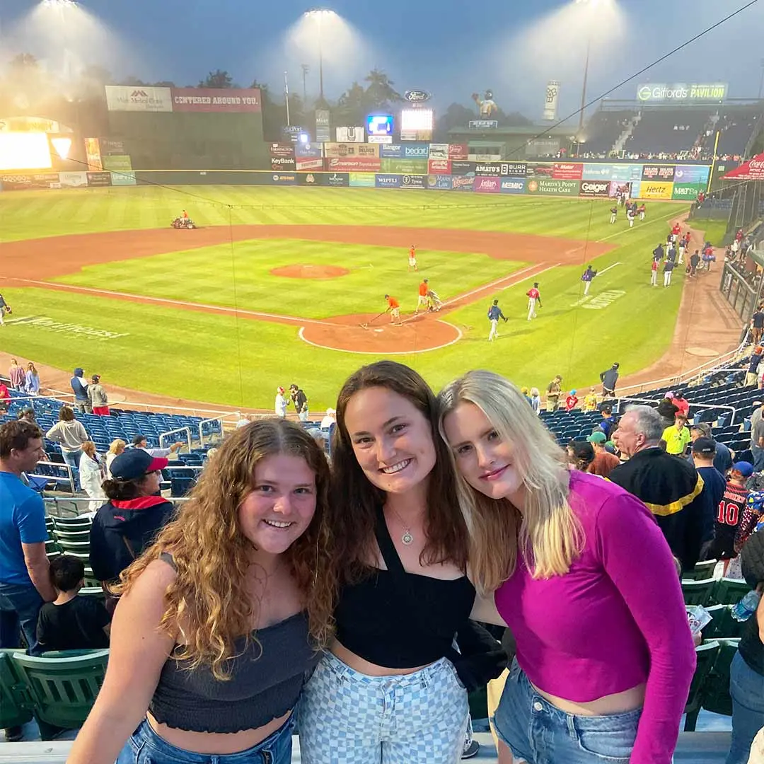 3 girls at baseball match