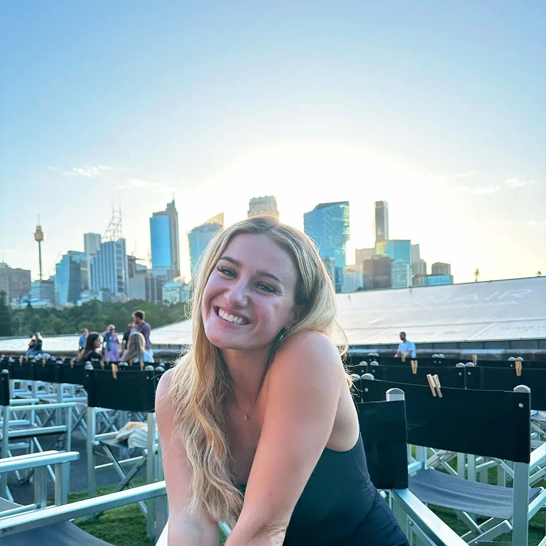 Girl smiles at camera in city