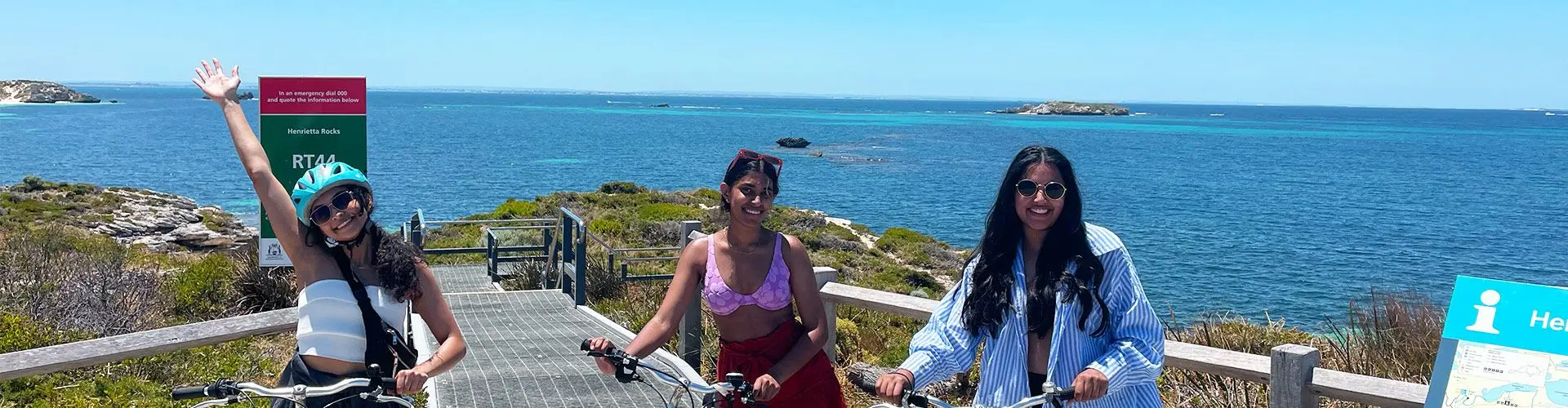 3 girls smile at camera on sunny coast