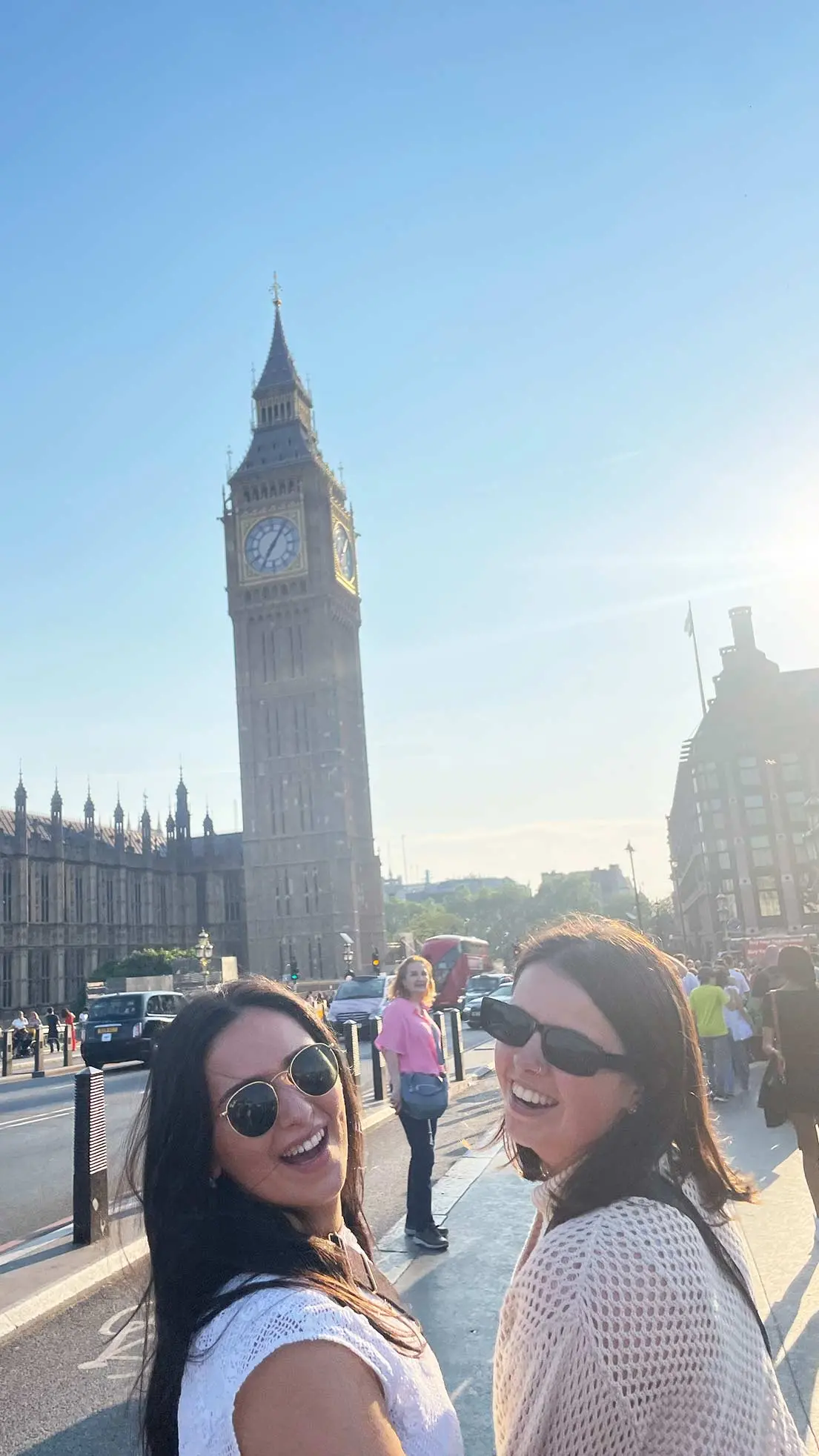 Girls look back at camera in London, big ben