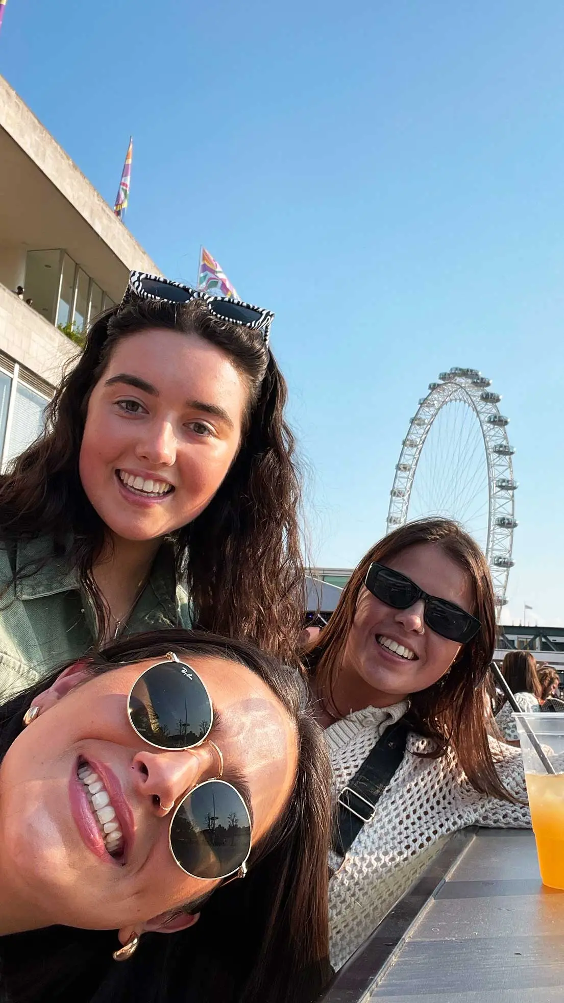 3 girls posing with London Eye behind