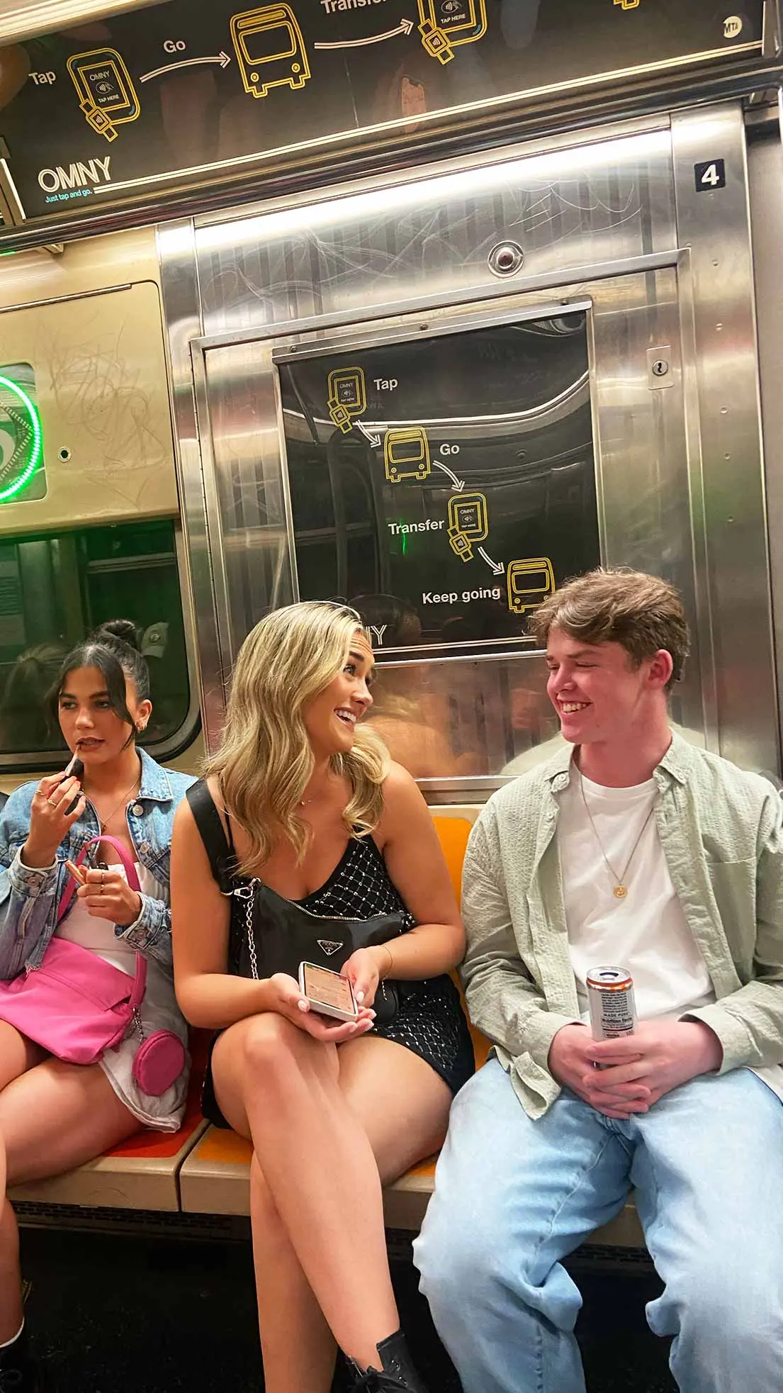 Guy and girls chat on subway in NYC.