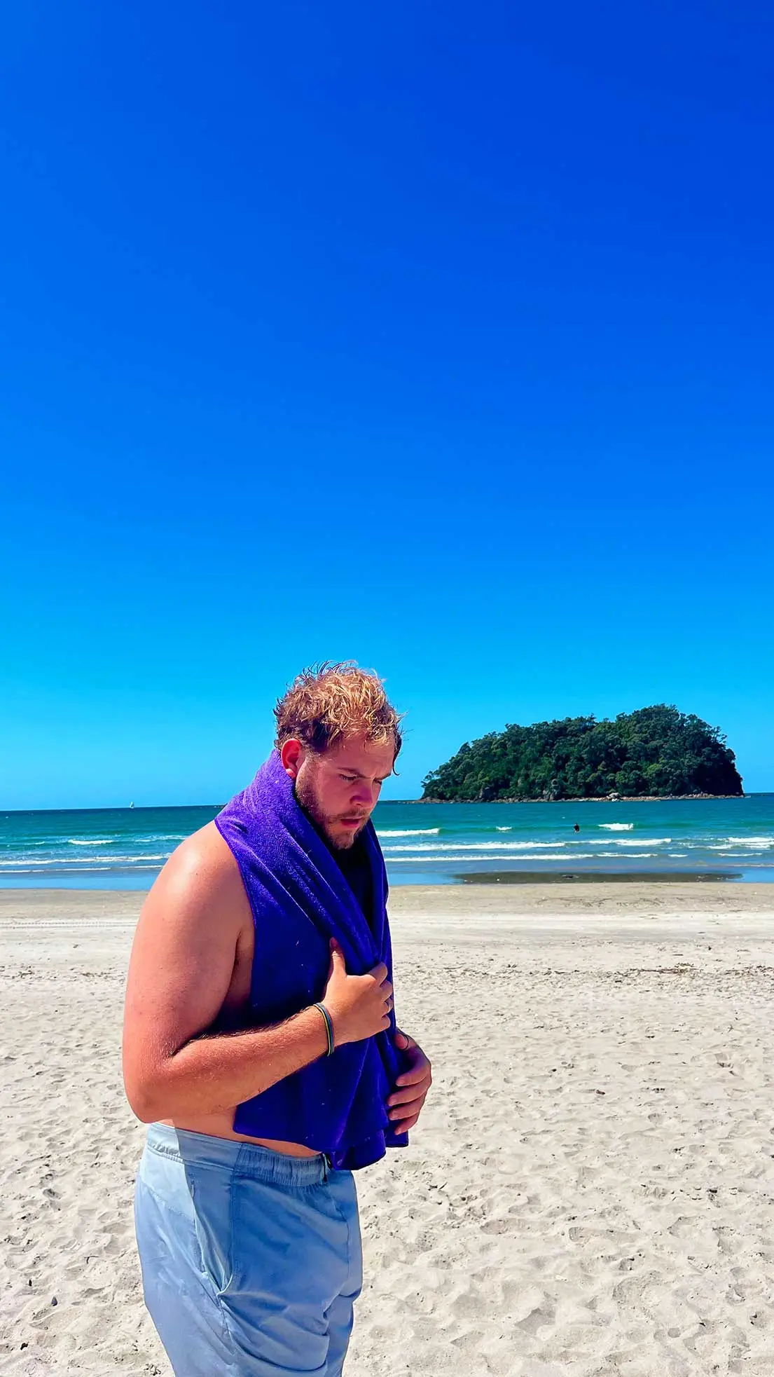 Guy dries off on beach