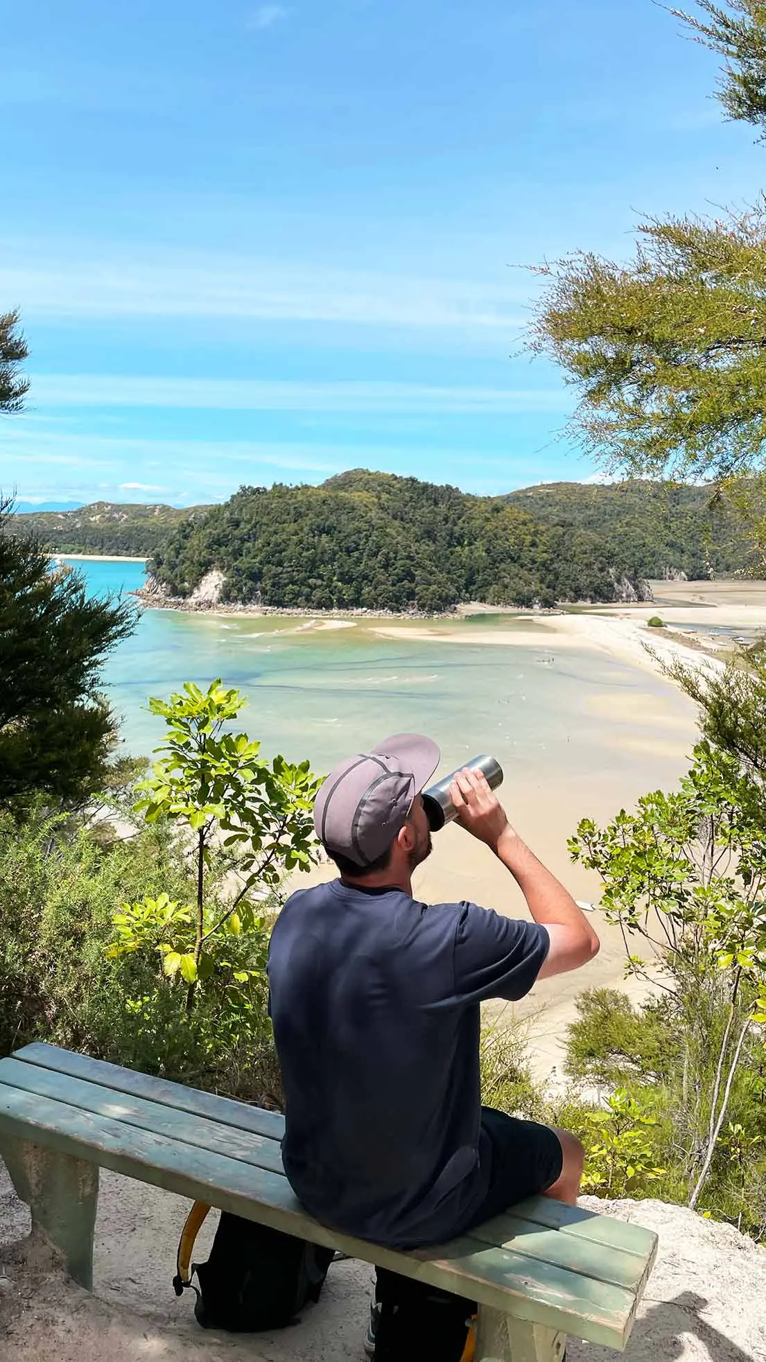 Guy drinks water in front of bay