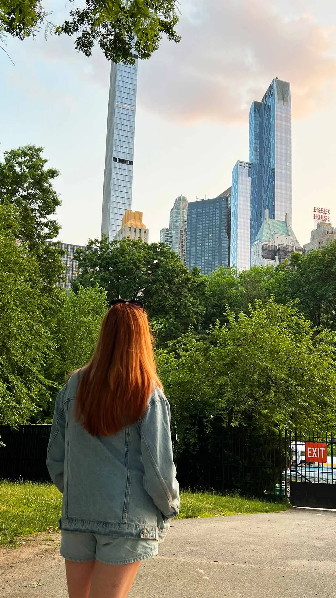 Girl looks out at park in Central Park, NYC