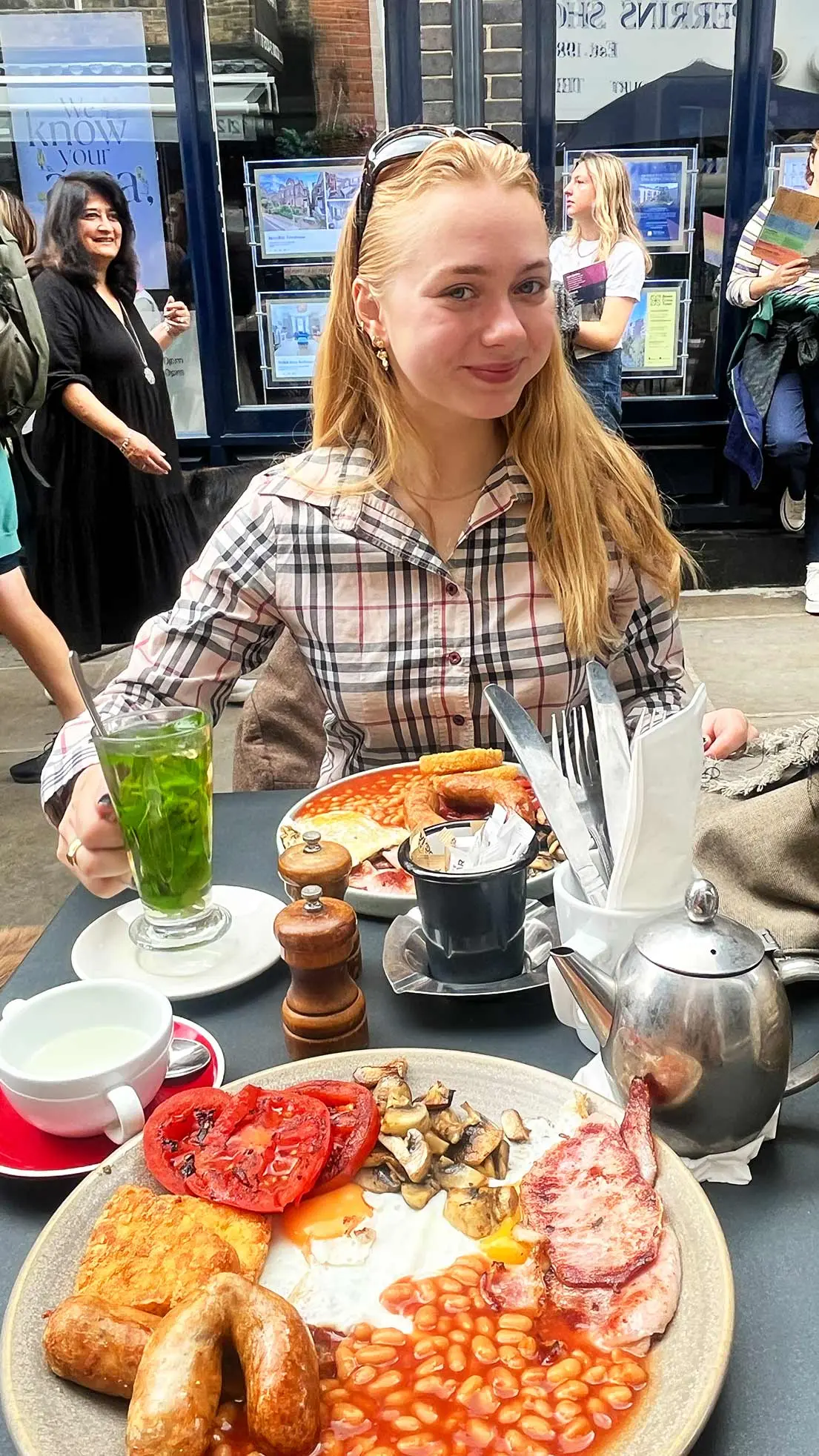 Girl looks happy with an English fry in front of her