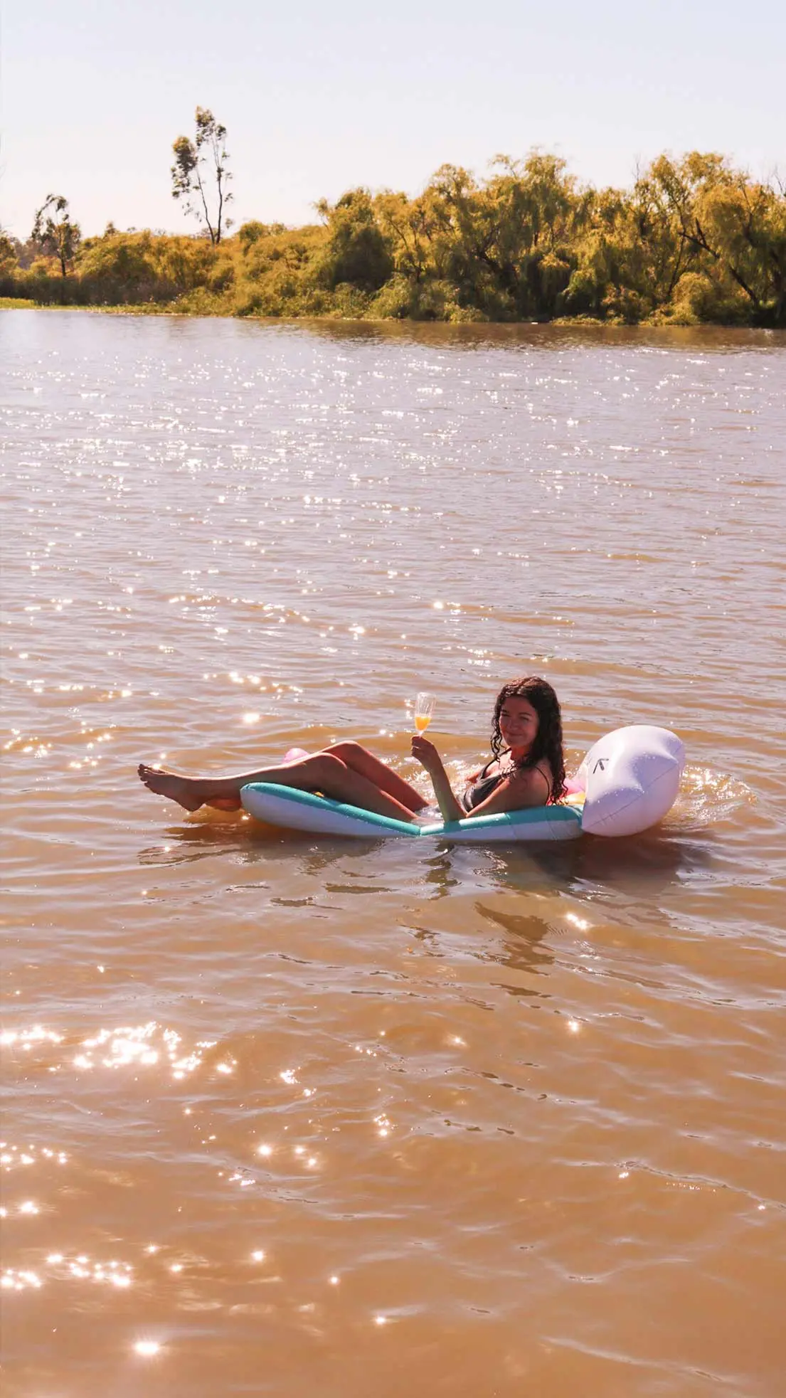 Girl sits on river in buyant device