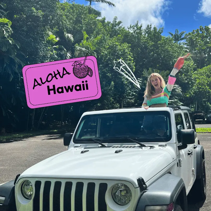 Aloha Hawaii! Girl stands in a jeep in front of Hawaiin nature.