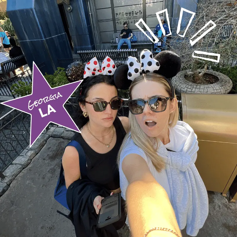 Two girls pose at Disneyland in LA with Minnie Mouse ears on 