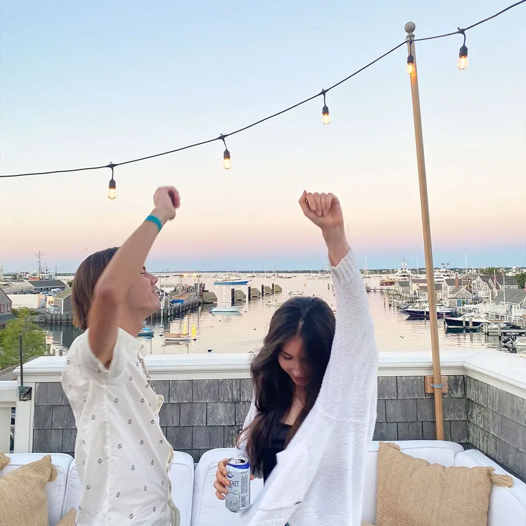 Guy and girl dance on a harbour