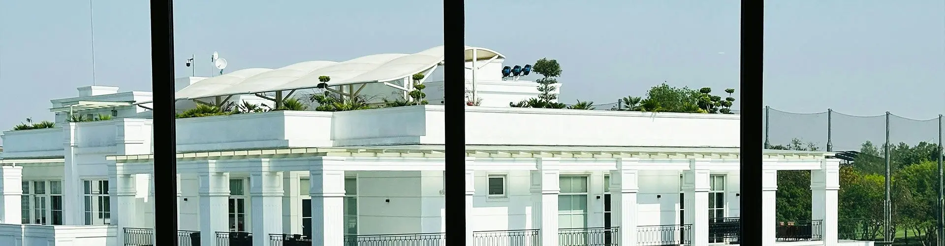 Rooftop with umbrellas on white building