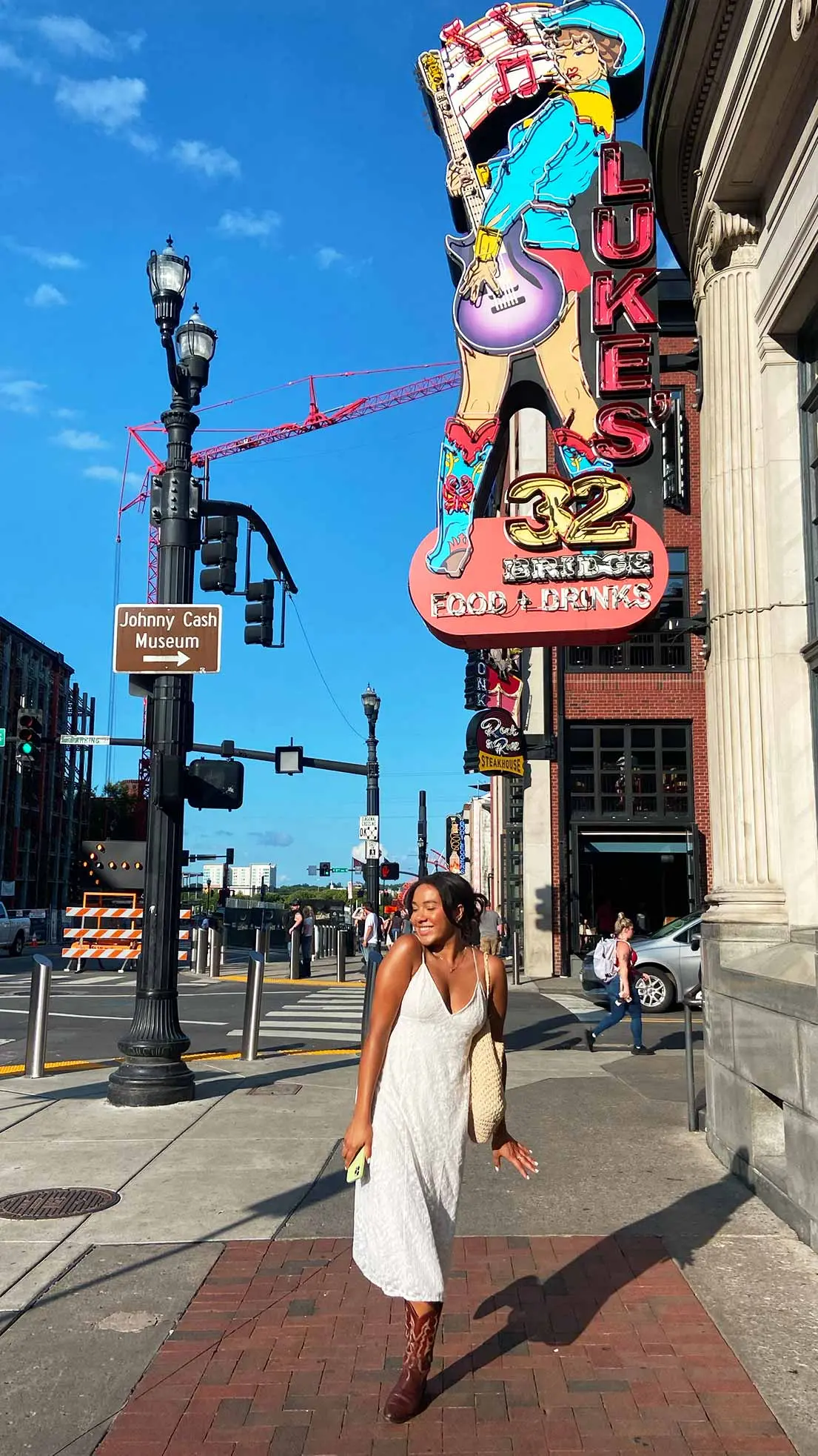 Girl poses with cowboy boots in Nashville.