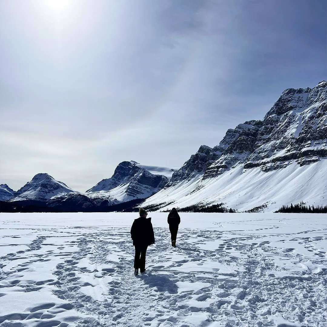 Snowy mountains with two people walking