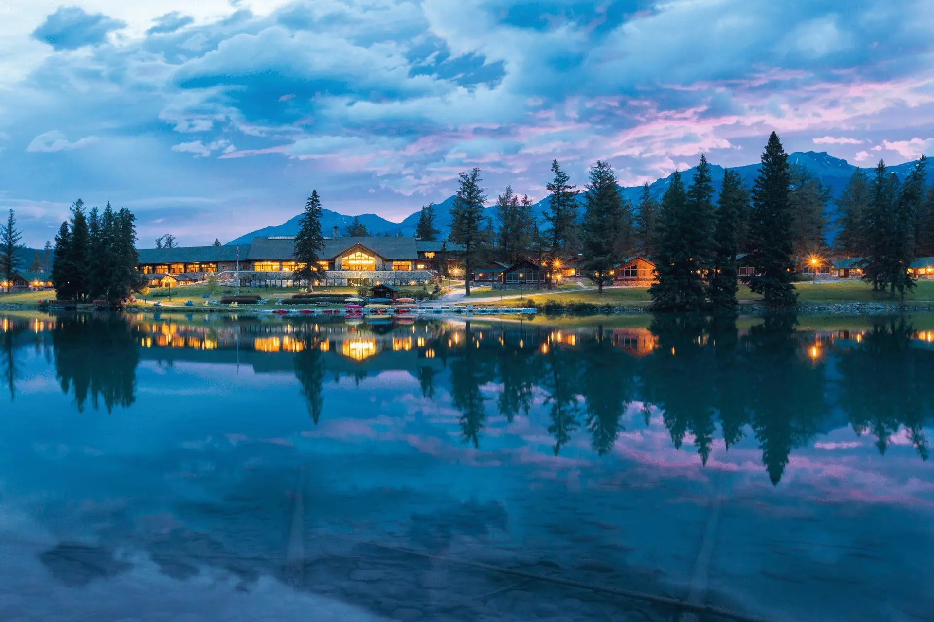 Sunset view of hotel over lake in Jasper Canada