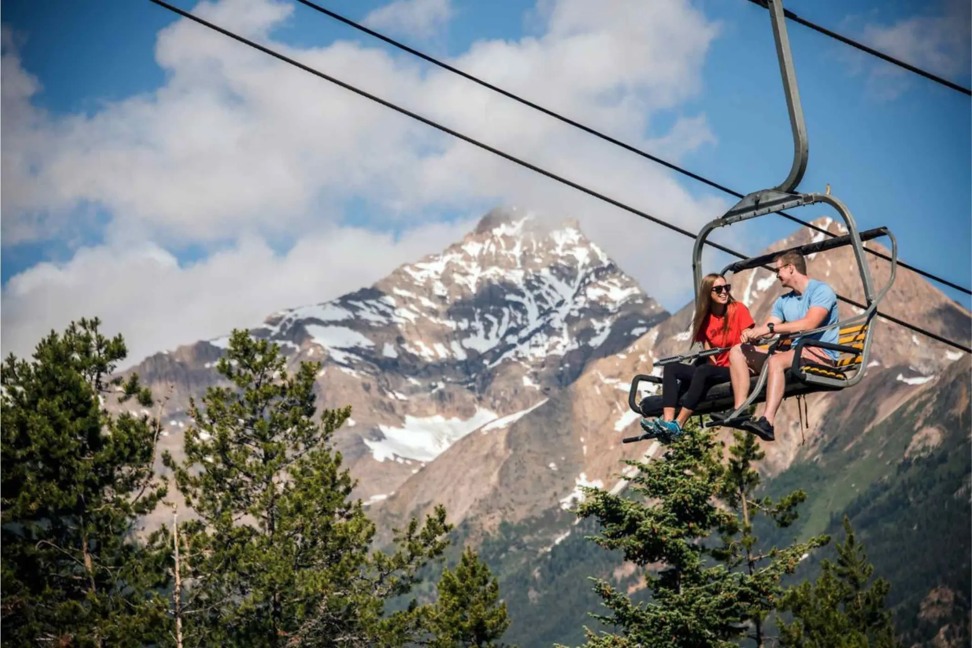 Couple up a ski lift in summer at Panorama resort in Canada