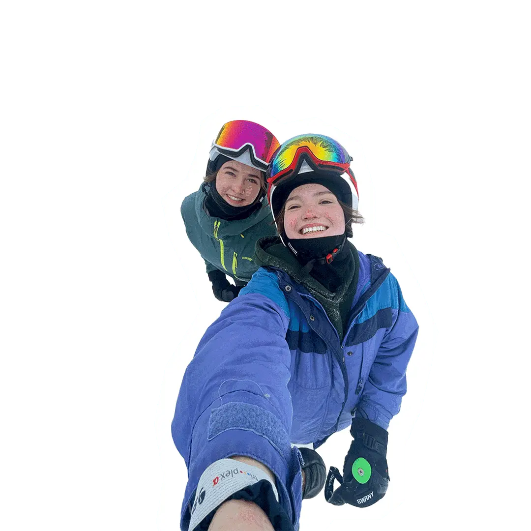 2 girls pose in ski-gear smiling