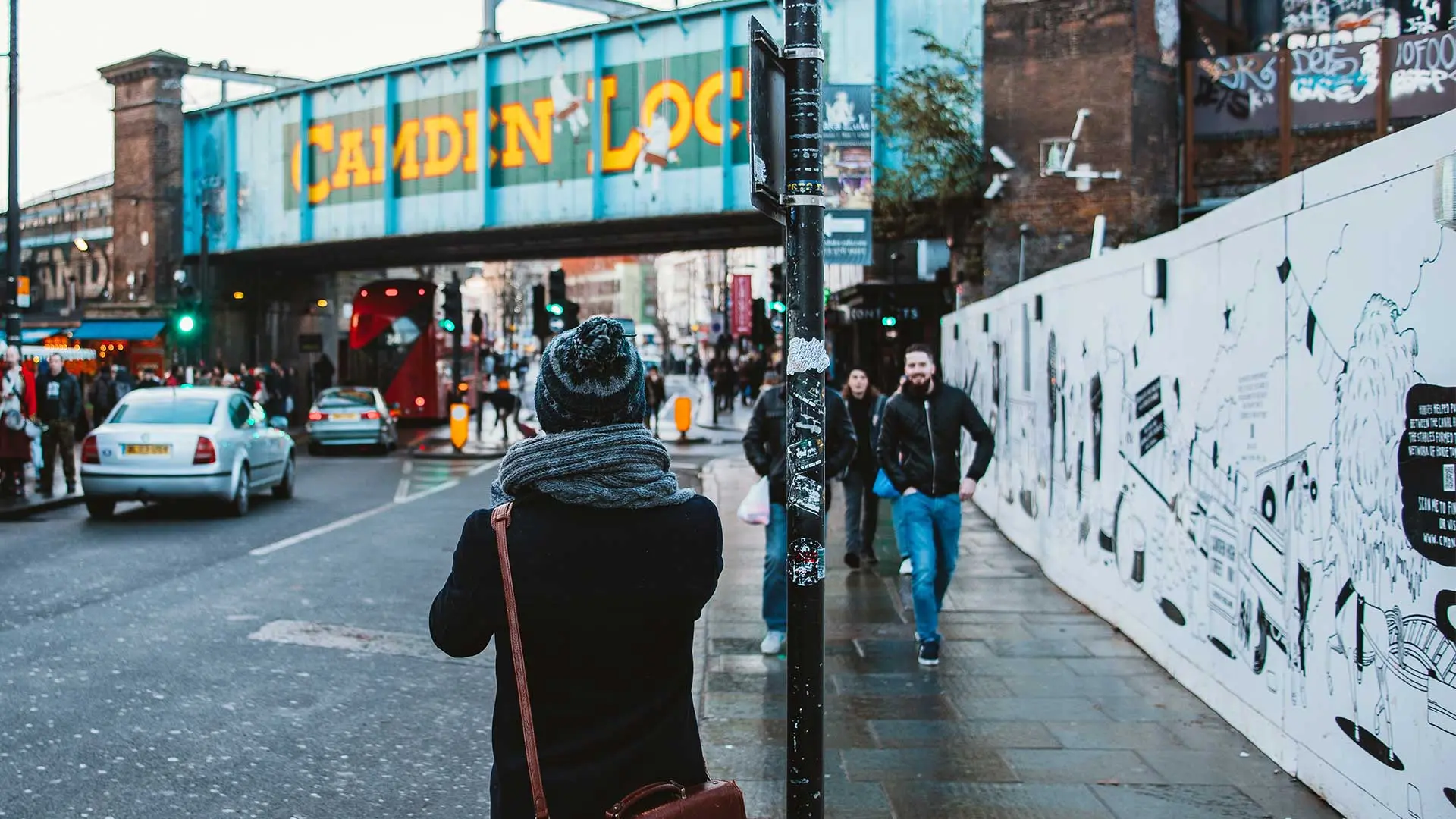 A young man takes a photo in front of Camden Lock - From Clem Onojeghuo via Unsplash