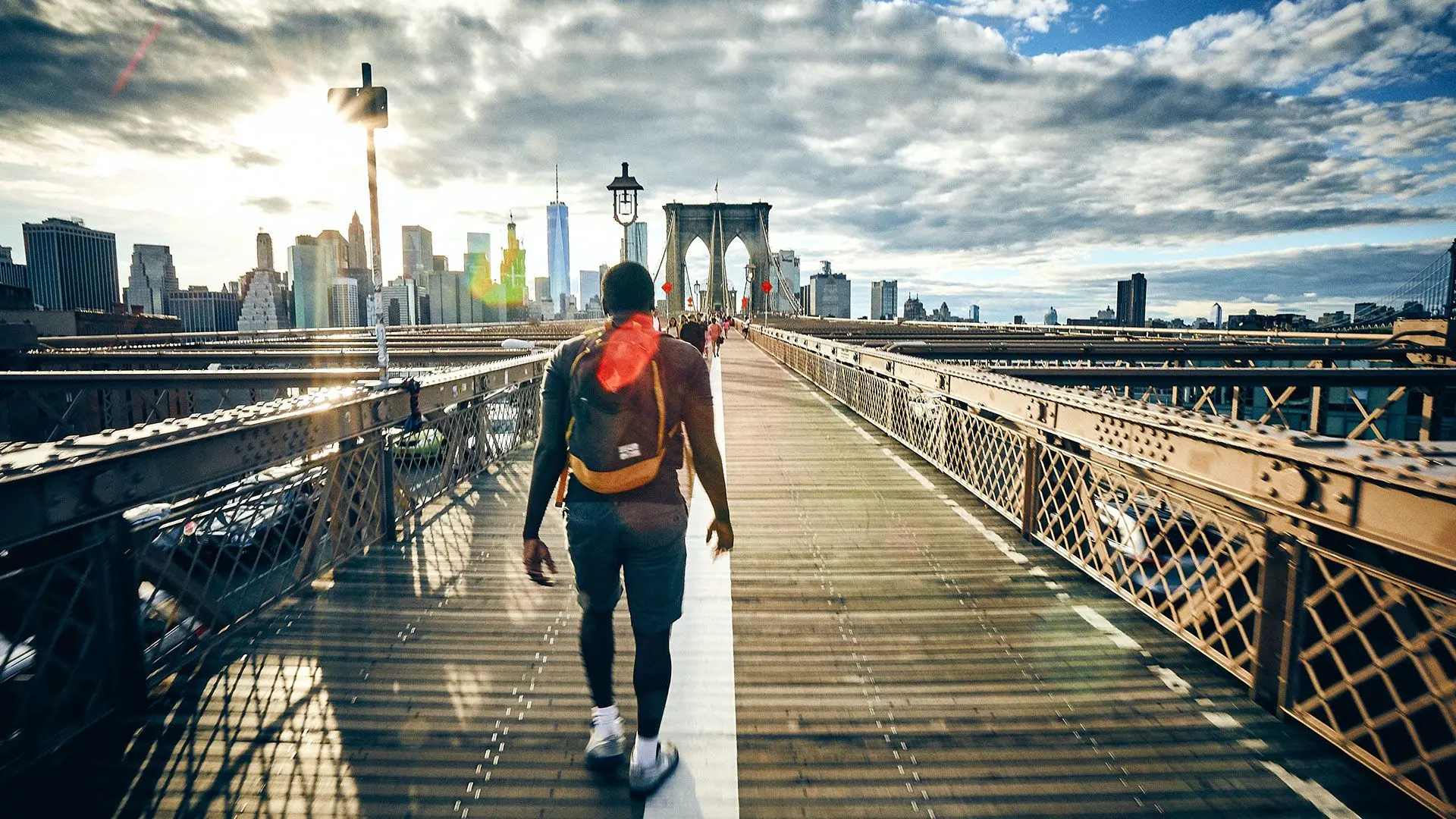 Man-walking-over-bridge-in-new-york - from Fabien Bazanegue via Unsplash
