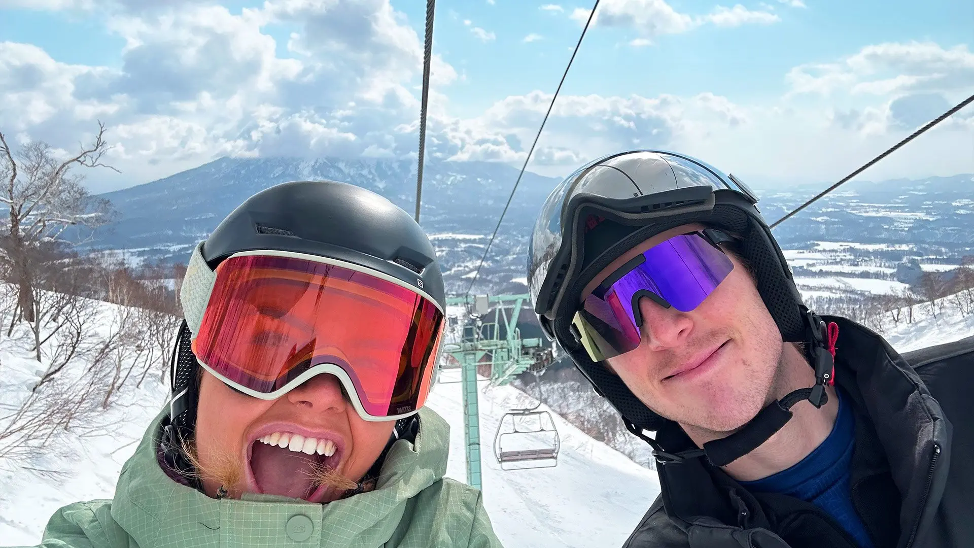 Guy and a girl smile for selfie on skilift